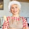 Professional female baker wearing a chef hat and apron