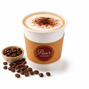 Cappuccino served in a branded Pam’s Bakery takeaway cup with coffee beans beside it.