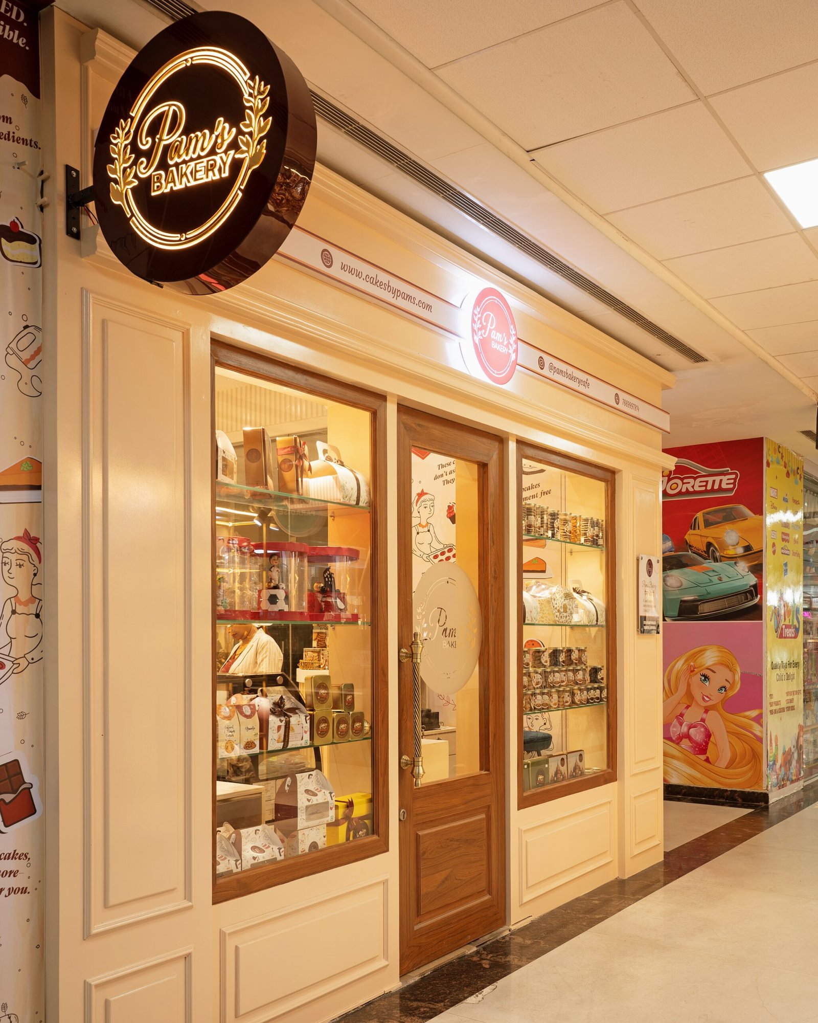 Pam's Bakery storefront with illuminated bakery signage and display windows
