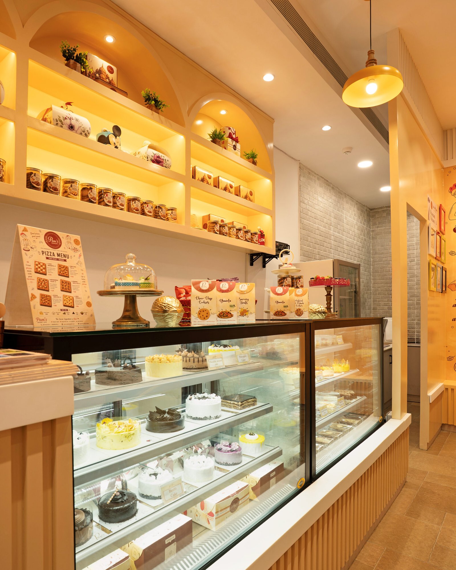 Pam’s Bakery cake display counter with assorted cakes, pastries, and packaged bakery products