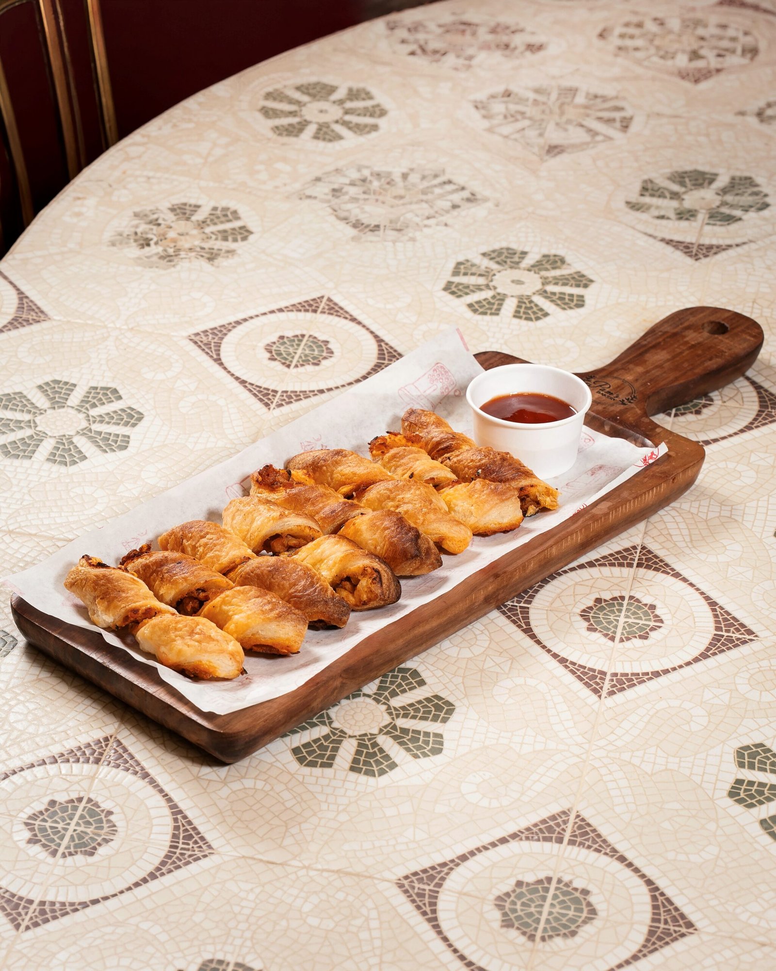 Freshly baked flaky pastries served with dipping sauce at Pam's Bakery