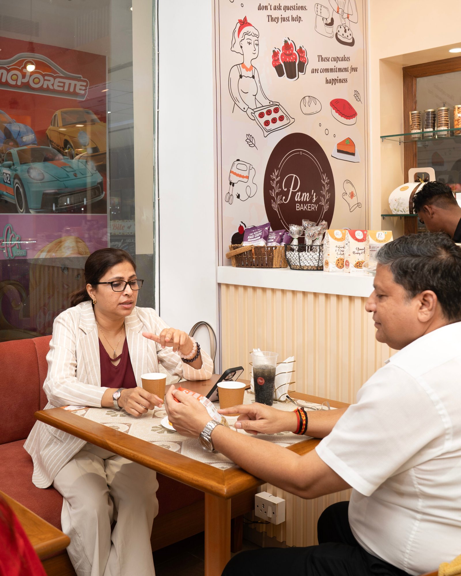 Customers enjoying food and drinks together at Pam's Bakery café