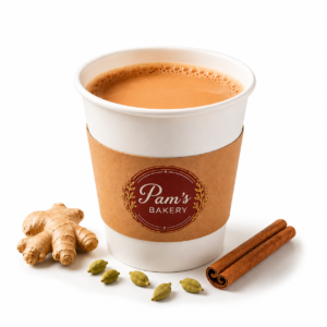Masala chai in a branded Pam’s Bakery takeaway cup with ginger, cardamom, and cinnamon.