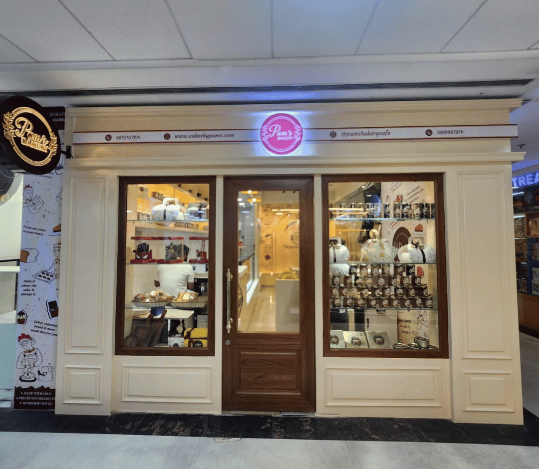 Pams Bakery Cafe storefront displaying cakes, desserts, and bakery products